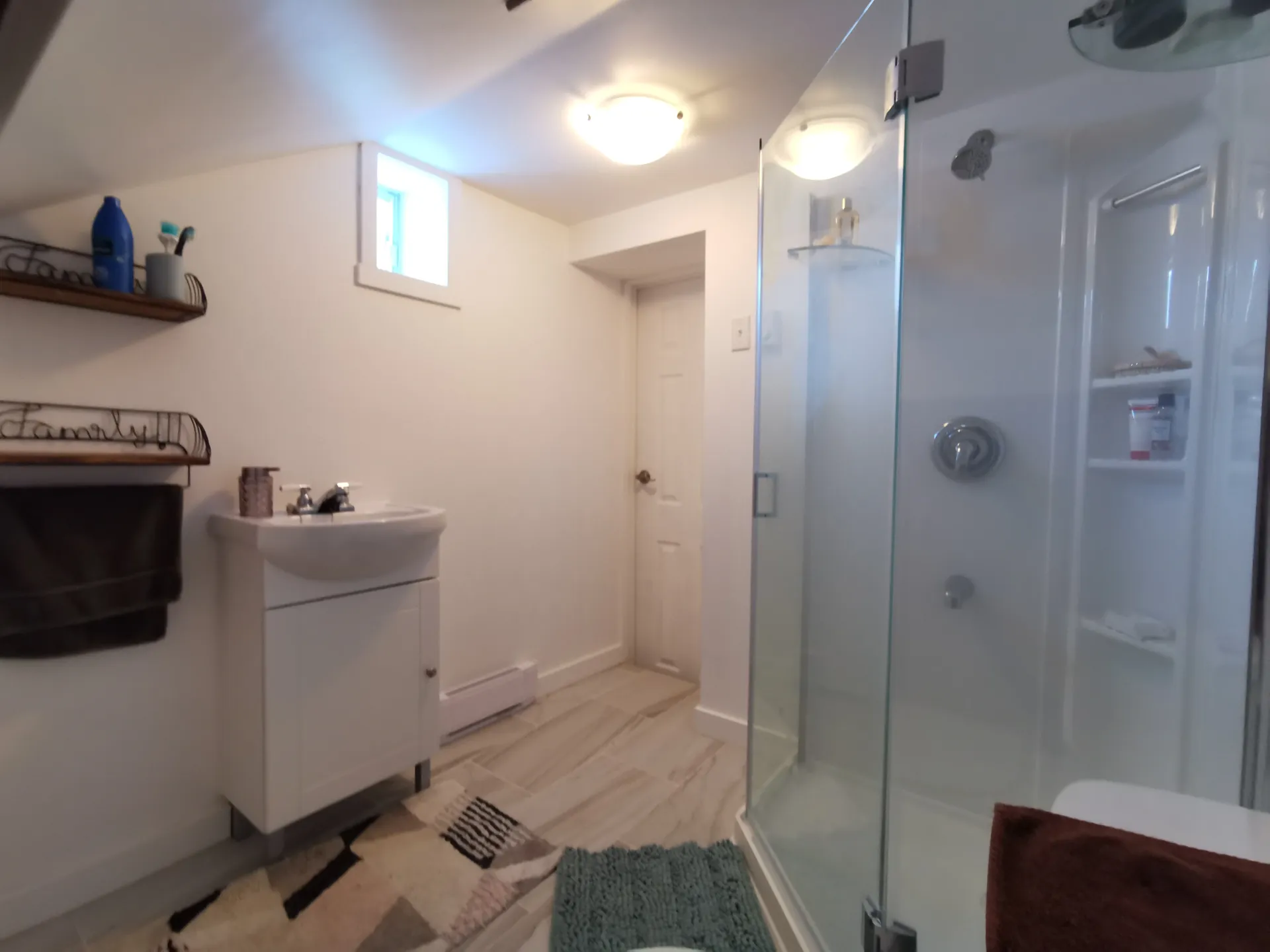 Basement bathroom with glass shower — Laval